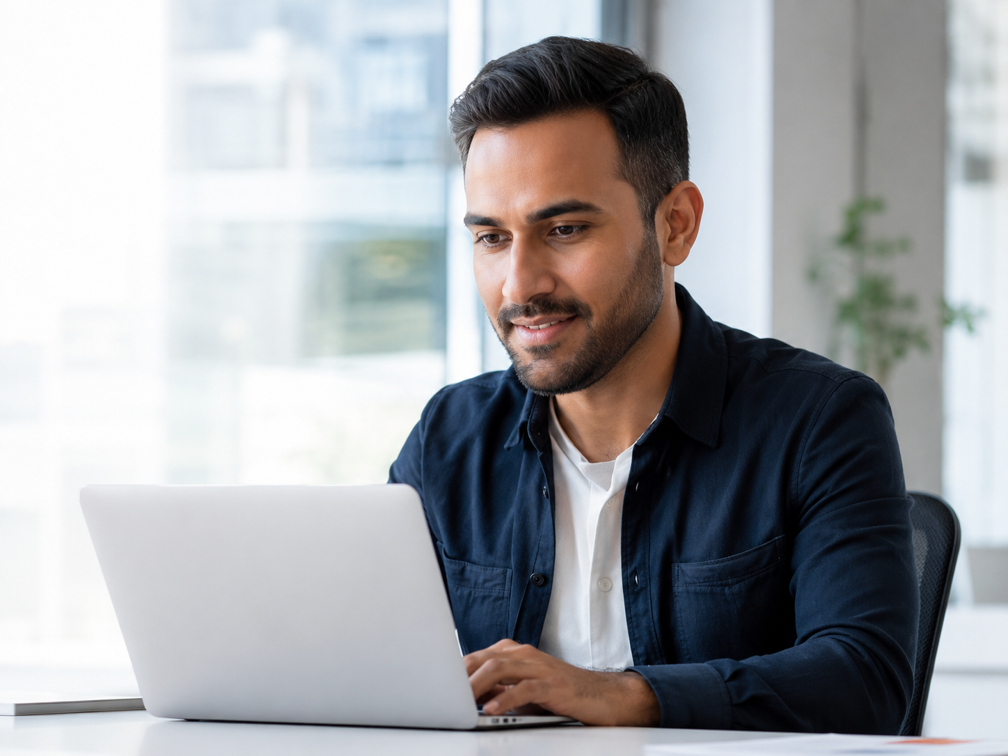 Sales professional working at a laptop